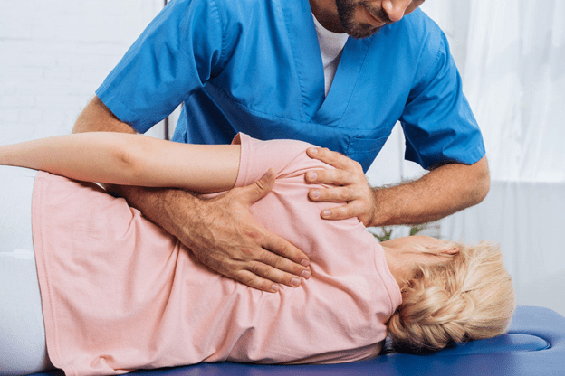 A therapist performing rehabilitating a patient